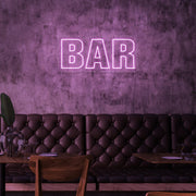 light pink bar neon sign hanging on bar wall