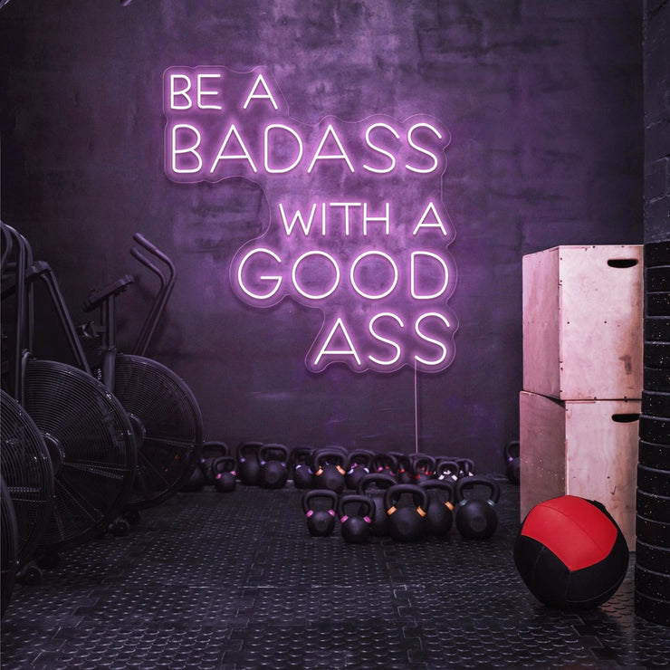light pink be a badass with a good ass neon sign hanging on gym wall
