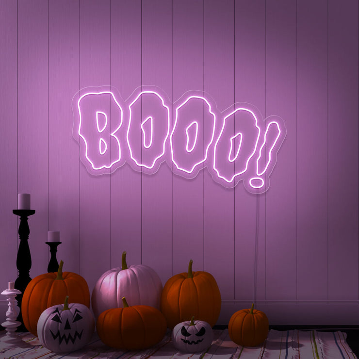 light pink boo neon sign with halloween pumpkins on floor