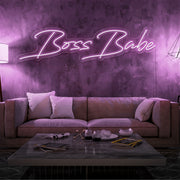 light pink boss babe neon sign hanging on living  room wall