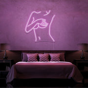 light pink cover up neon sign hanging on bedroom wall