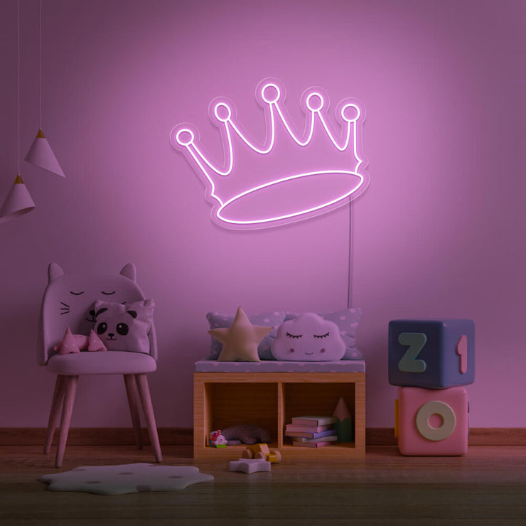 light pink crown neon sign hanging on kids bedroom wall