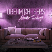 light pink dream chasers never sleep neon sign hanging on living room wall