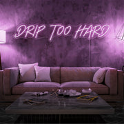 light pink drip too hard neon sign hanging on living room wall