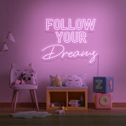 light pink follow your dreams neon sign hanging on kids bedroom wall