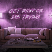 light pink get rich or die trying neon sign hanging  on living room wall