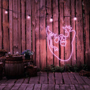 light pink ghost neon sign hanging on timber wall