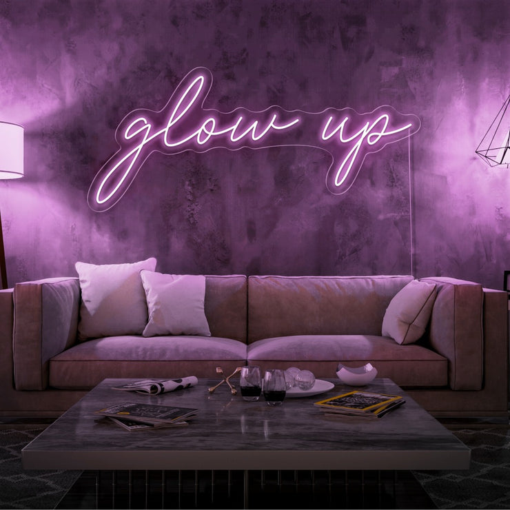 light pink glow up neon sign hanging on living room wall