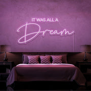 light pink it was all a dream neon sign hanging on bedroom wall