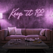 light pink keep it 100 neon sign hanging on living room wall