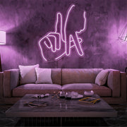 light pink LA fingers neon sign hanging on living room wall