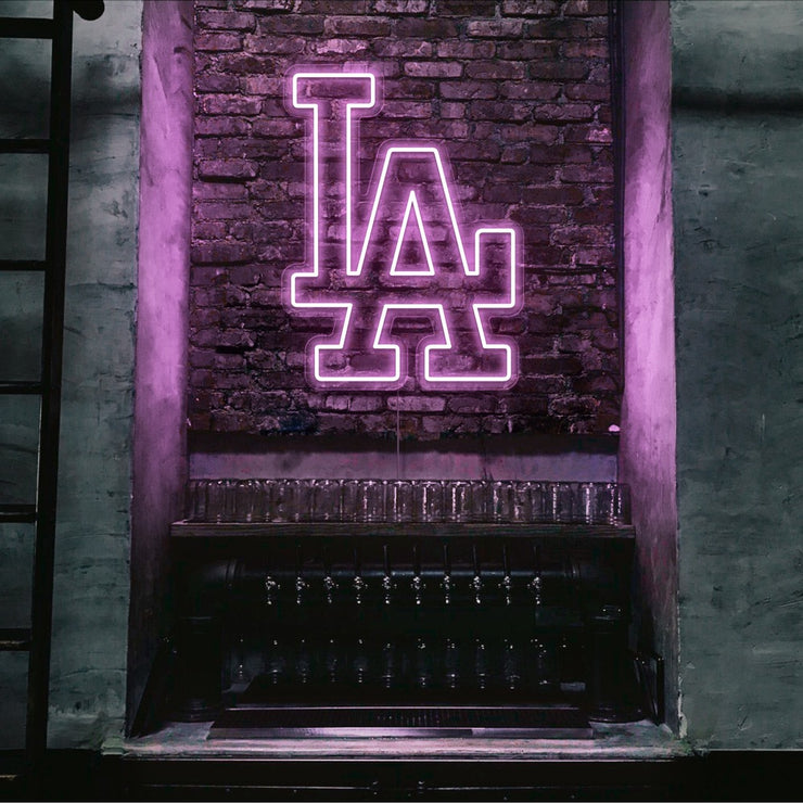 light pink LA neon sign hanging on bar wall