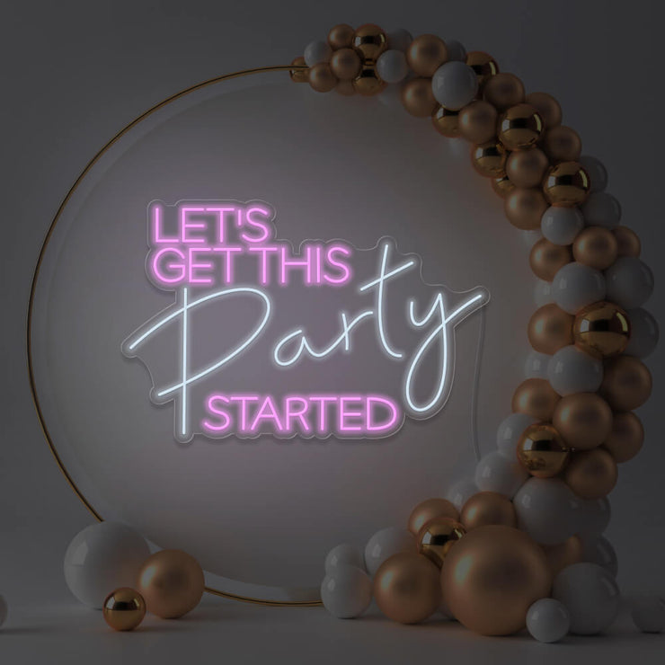light pink lets get this party started neon sign hanging in gold hoop frame