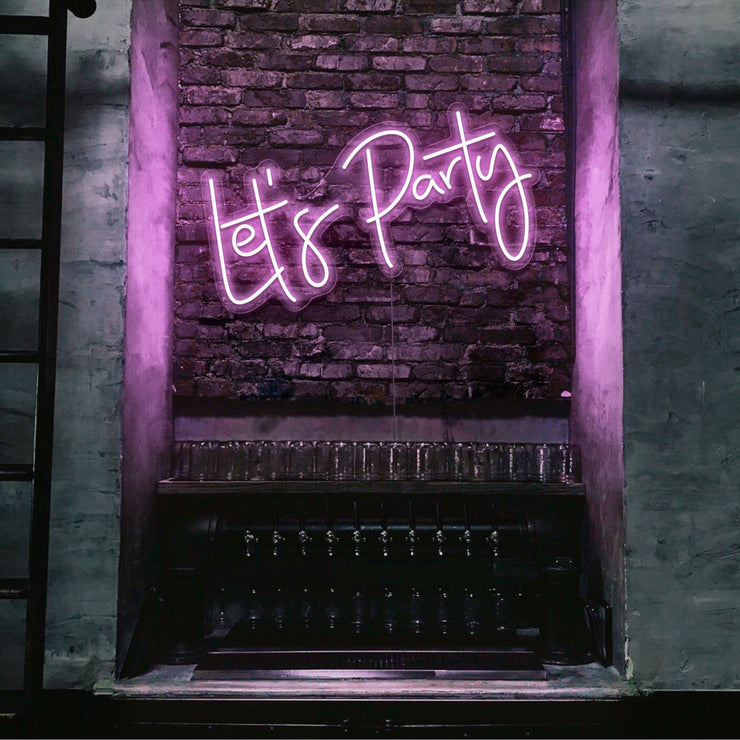light pink lets party neon sign hanging on bar wall