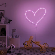 light pink love heart neon sign hanging on kids bedroom wall