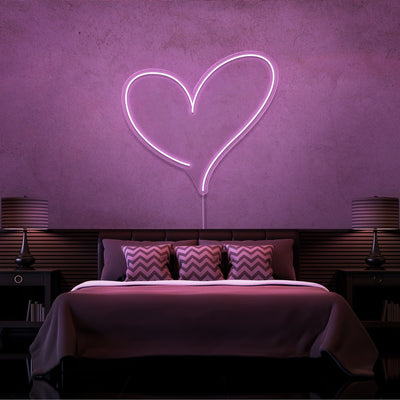 light pink love heart neon sign hanging on bedroom wall
