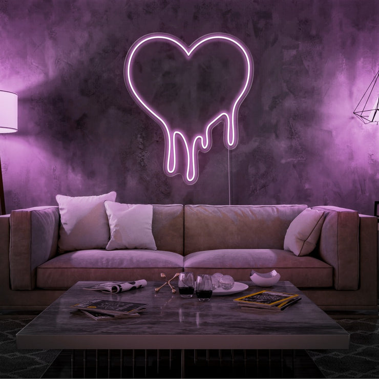 light pink melting heart neon sign hanging on living room wall