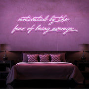 light pink motivated by the fear of being average neon sign hanging on bedroom wall