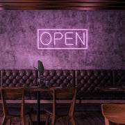 light pink open neon sign hanging on cafe wall