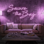 light pink secure the bag neon sign hanging on living room wall