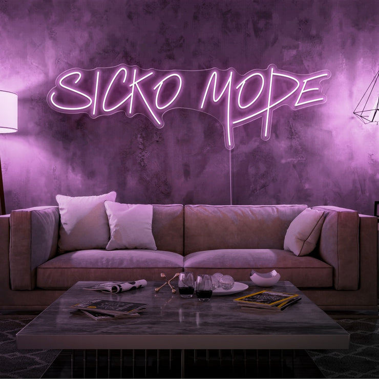 light pink sicko mode neon sign hanging on living room wall