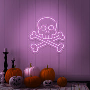 light pink skull bones neon sign with pumpkins on floor