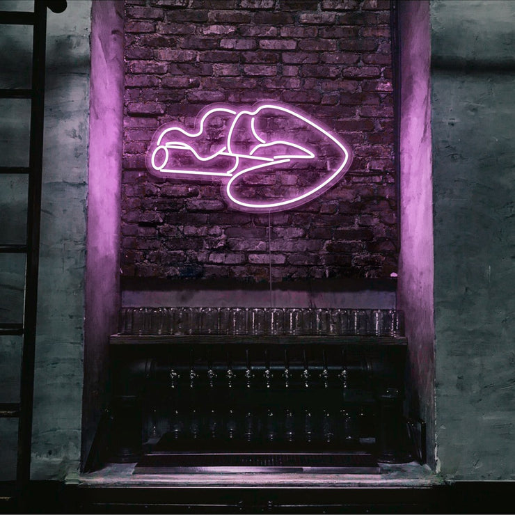 light pink smoking lips neon sign hanging on bar wall