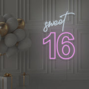 light pink sweet 16 neon sign hanging on wall