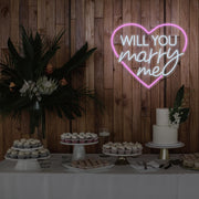 light pink will you marry me heart neon sign hanging on timber wall above dessert table