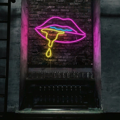 multicoloured dripping lips neon sign hanging on bar wall