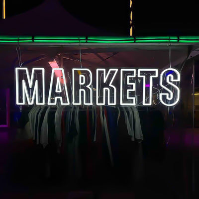 cold white markets neon sign hanging on marquee at outdoor event