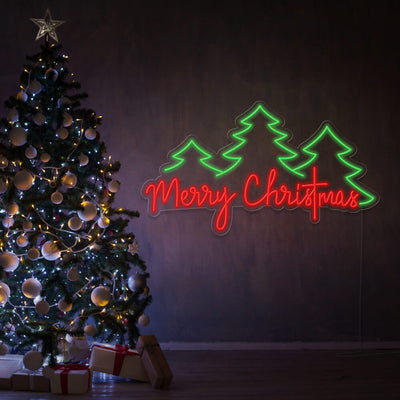 merry christmas trees neon sign hanging on wall next to christmas tree