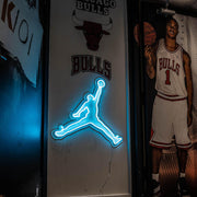 ice blue jordan jumpman neon sign hanging on wall next to chicago bulls player