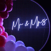 mr and mrs neon sign hanging on white mesh backdrop