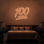 orange 100 neon sign hanging on bedroom wall