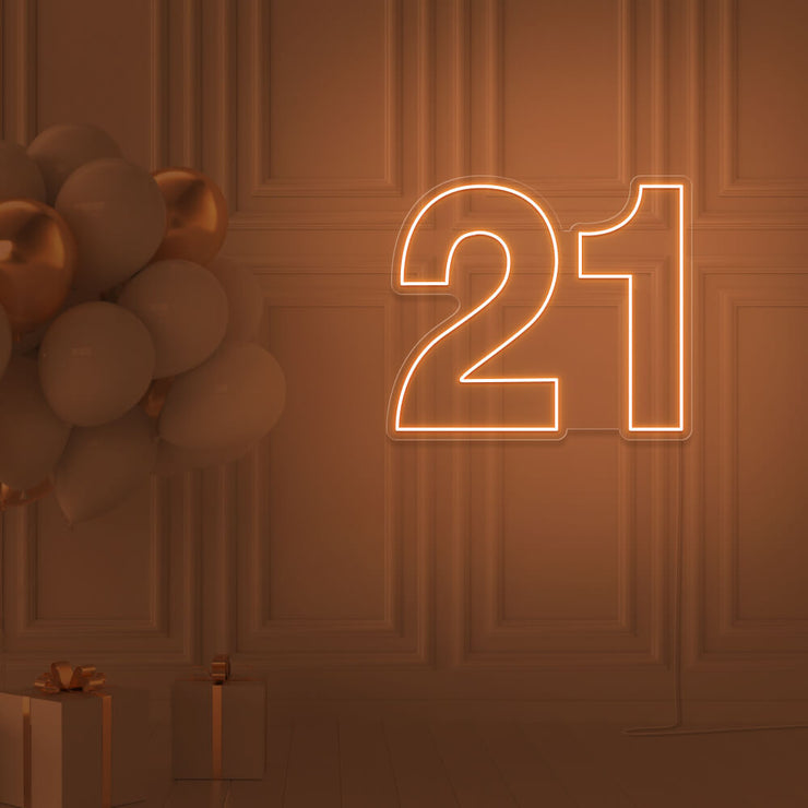 orange  21 neon sign hanging on wall with balloons