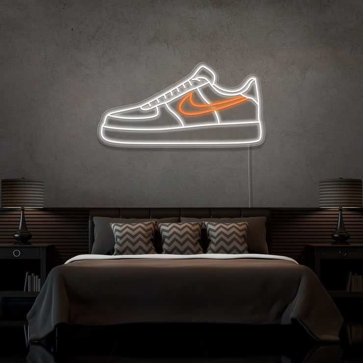 orange air force 1 nike sneaker neon sign hanging on bedroom wall