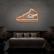 orange air jordan 1 sneaker neon sign hanging on bedroom wall
