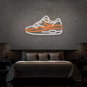 orange air max 1 sneaker neon sign hanging on bedroom wall