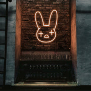 orange bad bunny neon sign hanging on bar wall