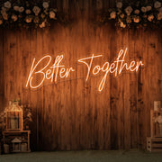 orange better together neon sign hanging on timber wall