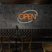 orange open neon sign hanging on restaurant wall
