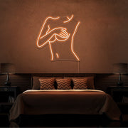 orange cover up neon sign hanging on bedroom wall