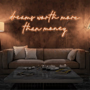 orange dreams worth more than money neon sign hanging on living  room wall