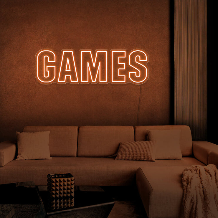 orange games neon sign hanging on games room wall