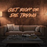 orange get rich or die trying neon sign hanging  on living room wall