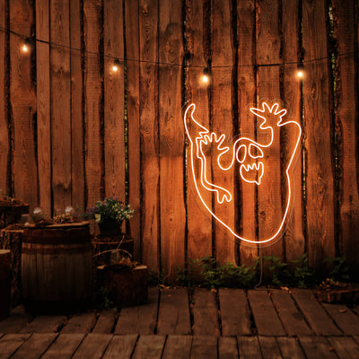 orange ghost neon sign hanging on timber wall