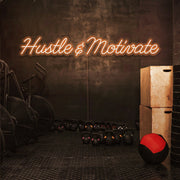 orange hustle and motivate neon sign hanging on gym wall