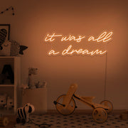 orange it was all a dream neon sign hanging on kids bedroom wall