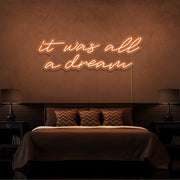 orange it was all a dream neon sign hanging on bedroom wall